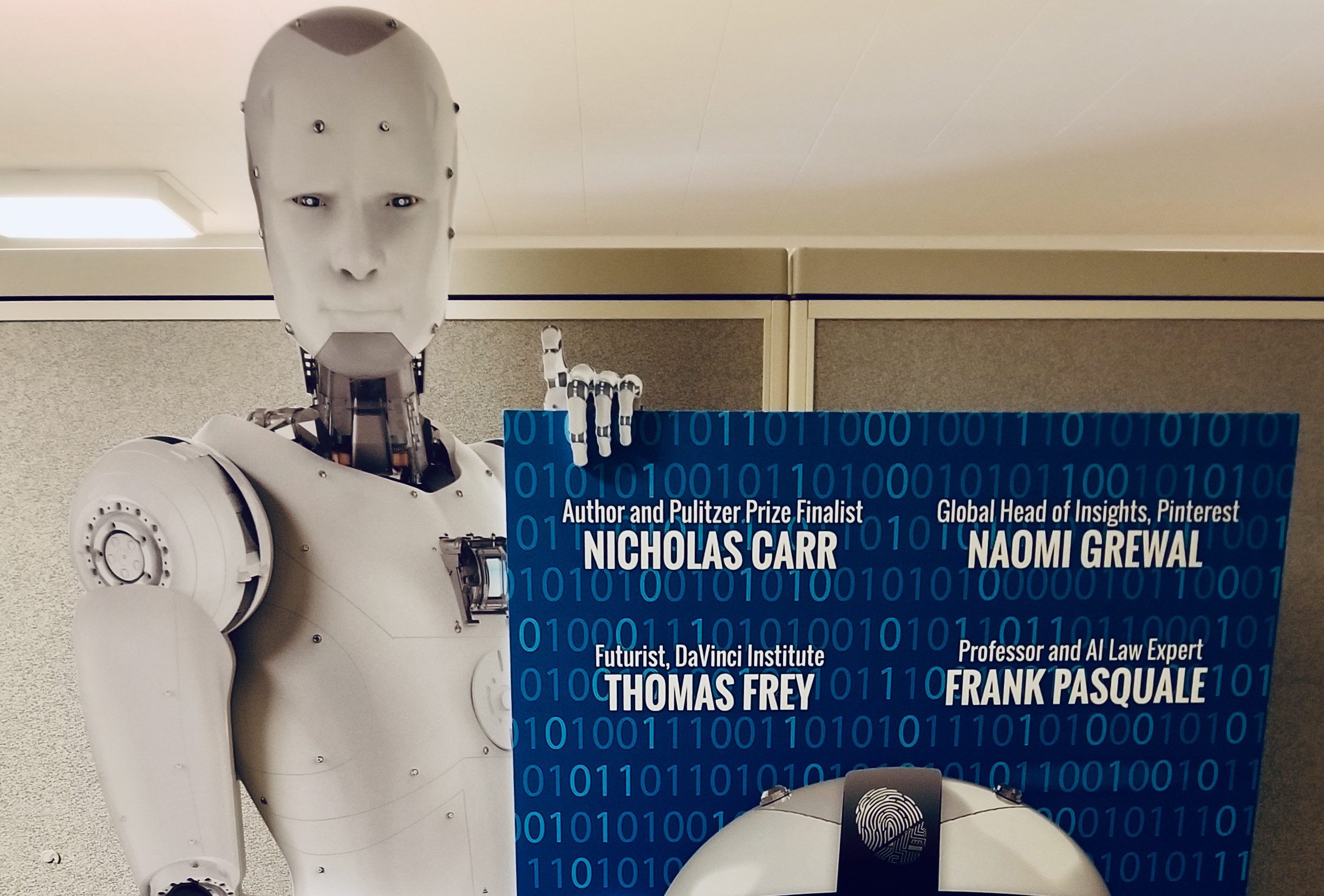 Cardboard cutout of a robot holding a Dawn or Doom poster